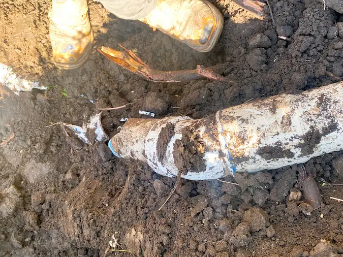 Exposed damaged sewer line being evaluated for a localized repair