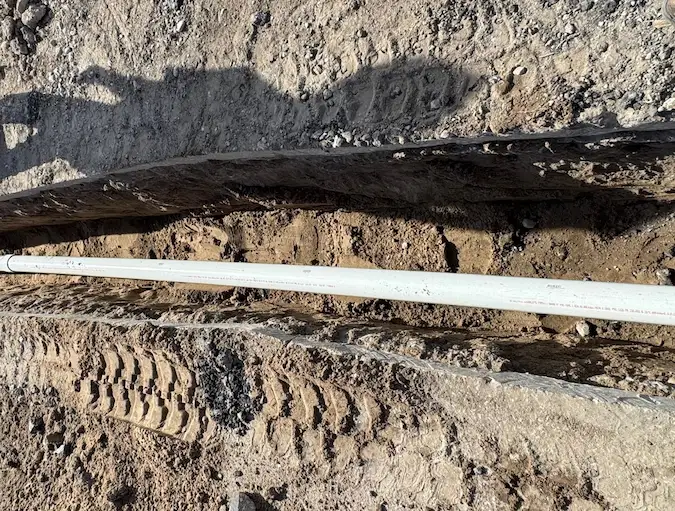 PD Plumbing crew installing new PVC during an open-trench sewer replacement in Wichita