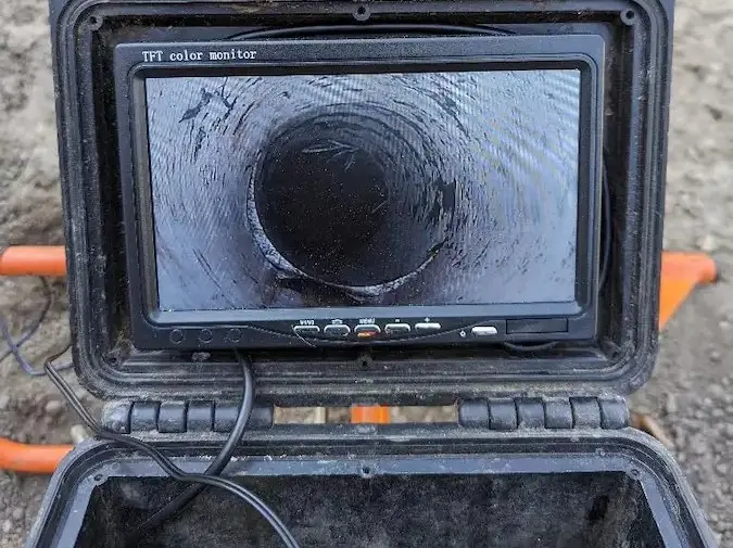 Sewer camera monitor displaying the interior of an accessible pipe