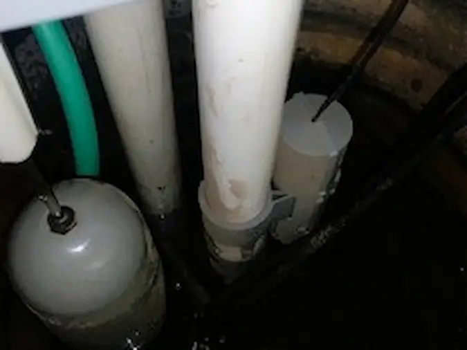 Sump pump check valve and discharge piping