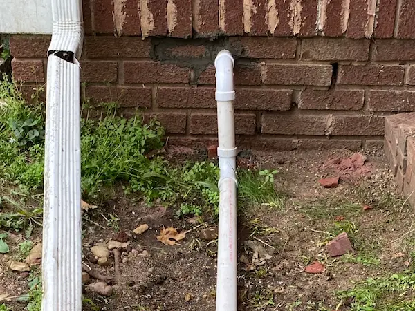 Exterior sump pump discharge line in a yard