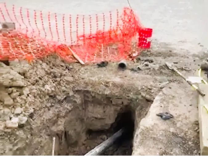 PD Plumbing pipe-bursting sewer replacement beneath a commercial concrete parking lot