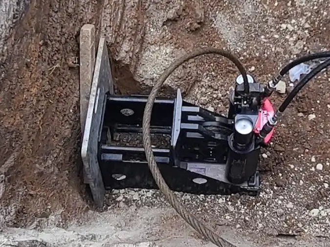 Pipe-bursting equipment positioned inside a sewer access pit