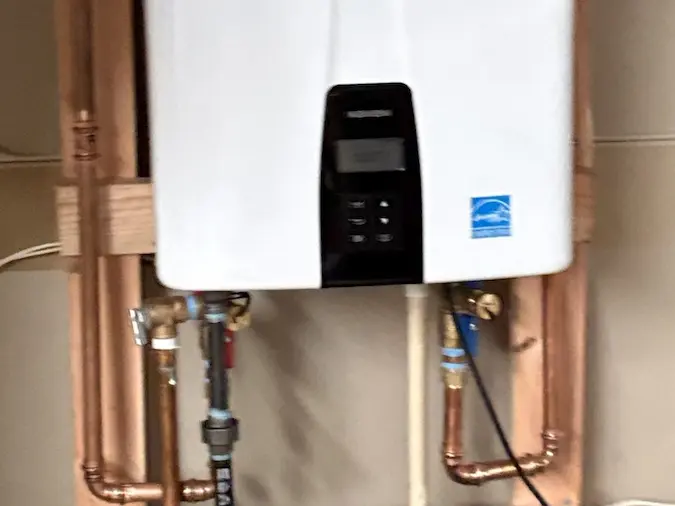 Completed Navien tankless water heater installation with connected piping