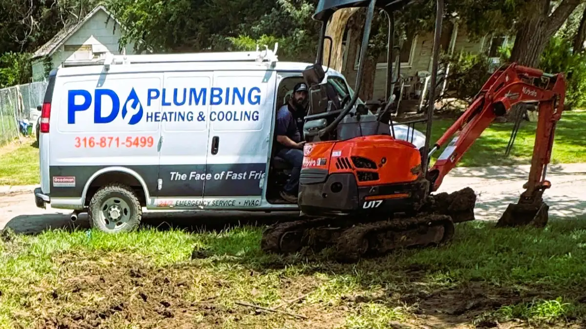 PD Plumbing Heating and Cooling service van and excavator at a Wichita job