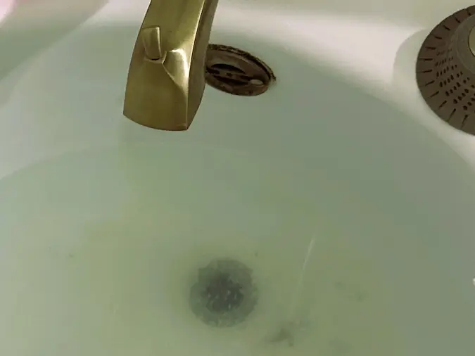 Standing water in a bathtub caused by a slow or blocked drain