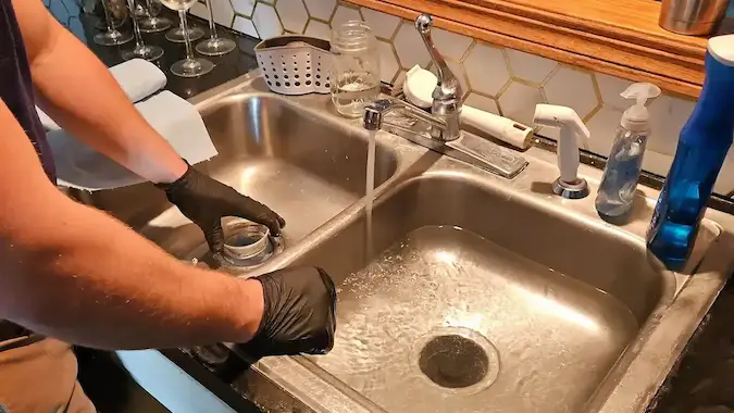Kitchen sink drain cleaning by PD Plumbing Heating and Cooling