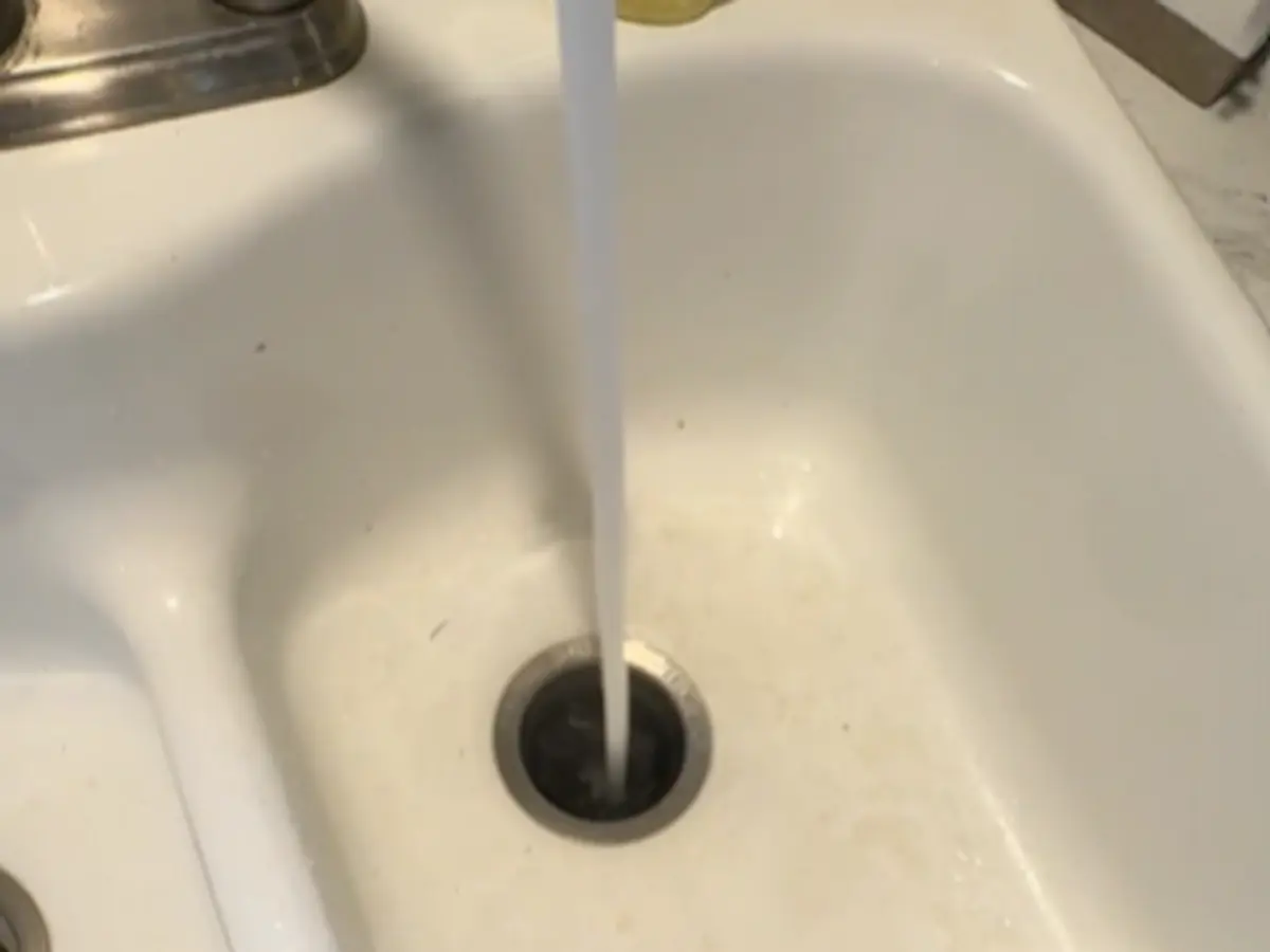 Kitchen sink drain service with water running after drain cleaning