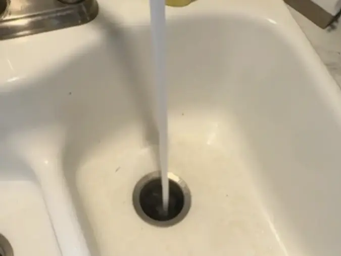 Kitchen sink drain service with water running after drain cleaning