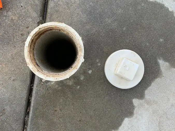 Open outdoor sewer cleanout for main sewer line cleaning