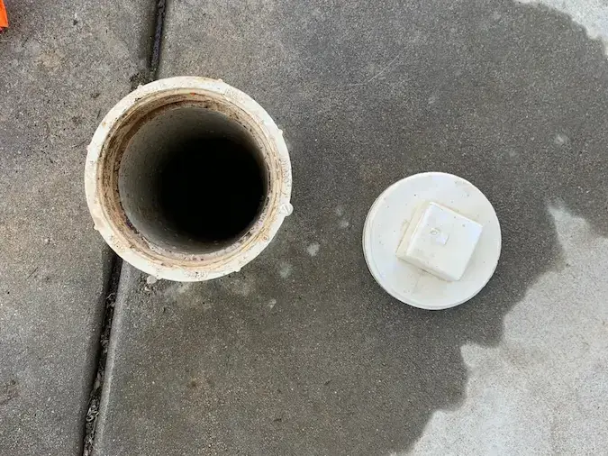 Open outdoor sewer cleanout for main sewer line cleaning