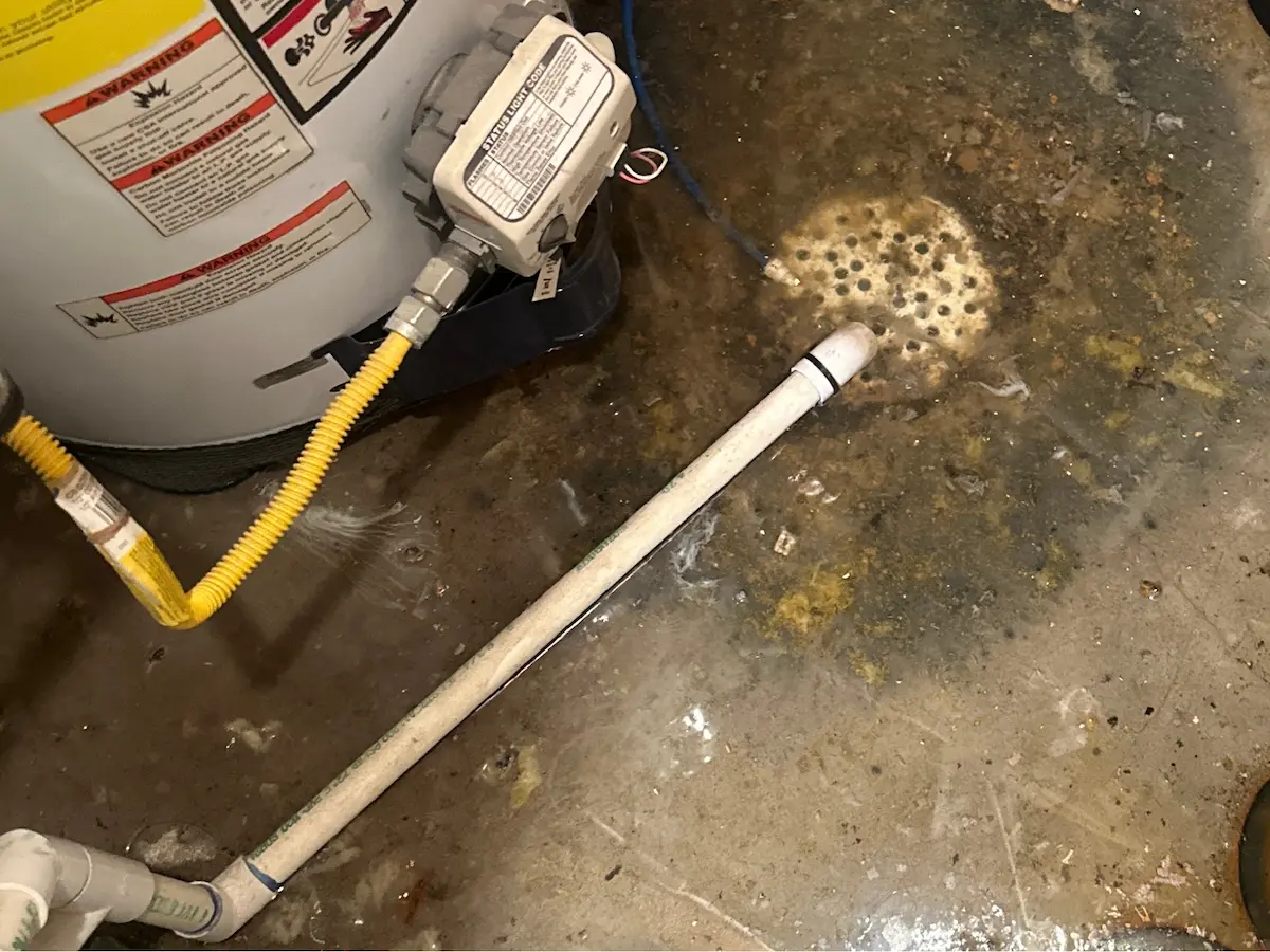 Basement floor drain backup with standing water before drain cleaning