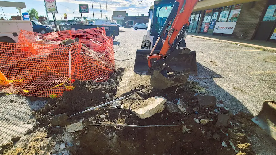 Commercial sewer and drain repair excavation in a parking lot