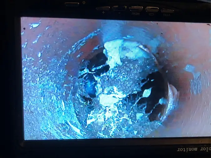 Sewer camera inspection showing a damaged pipe section