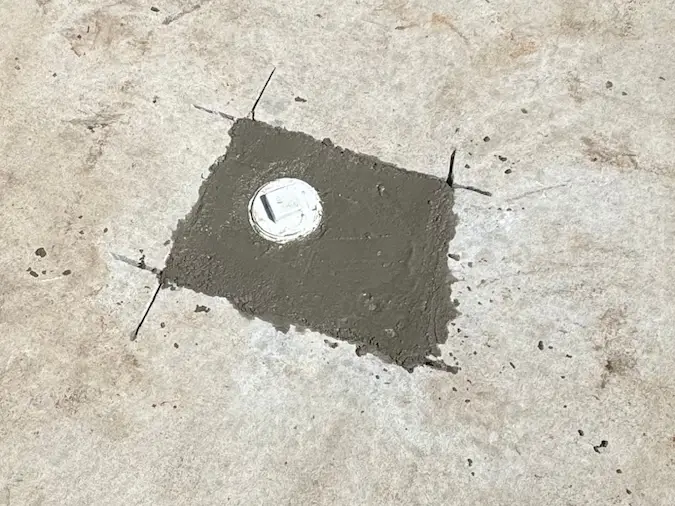 Finished concrete cleanout patch after a PD Plumbing sewer line repair