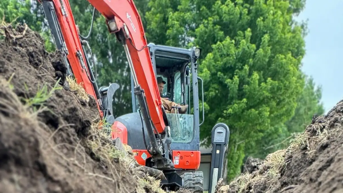PD Plumbing sewer line repair excavation with mini excavator in a Wichita-area yard