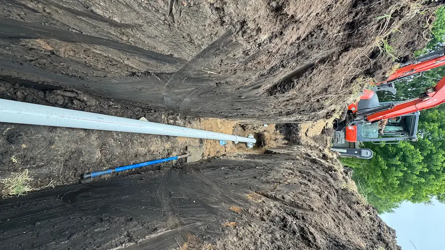 New PVC sewer line installed in an open trench