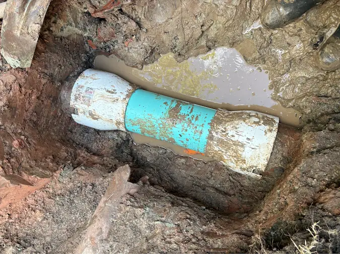Completed PVC sewer transition repair connecting existing sewer sections