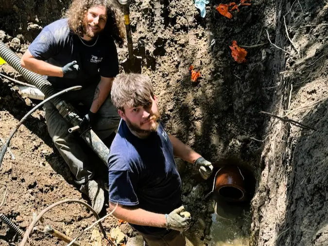 PD Plumbing crew exposing a broken clay sewer section for localized repair