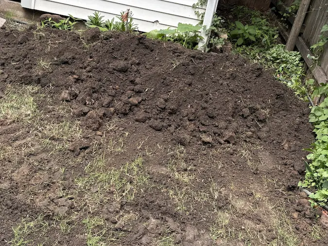Yard returned to rough backfill after a localized sewer repair