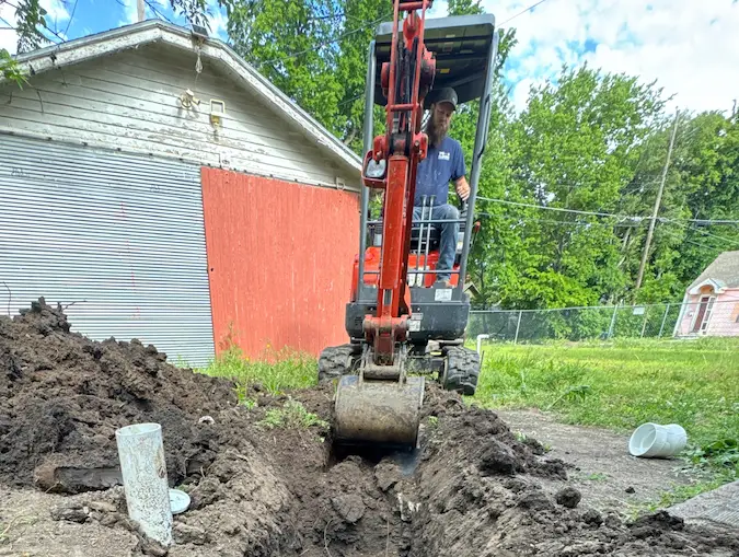 PD Plumbing excavator opening a residential sewer replacement trench