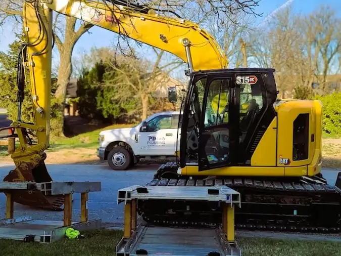 PD Plumbing excavation equipment and service truck prepared for sewer line replacement