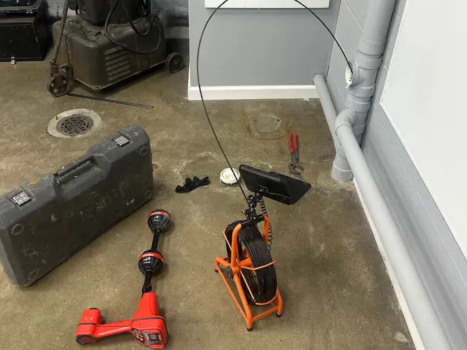 Sewer camera and locating equipment set up at an indoor floor access point