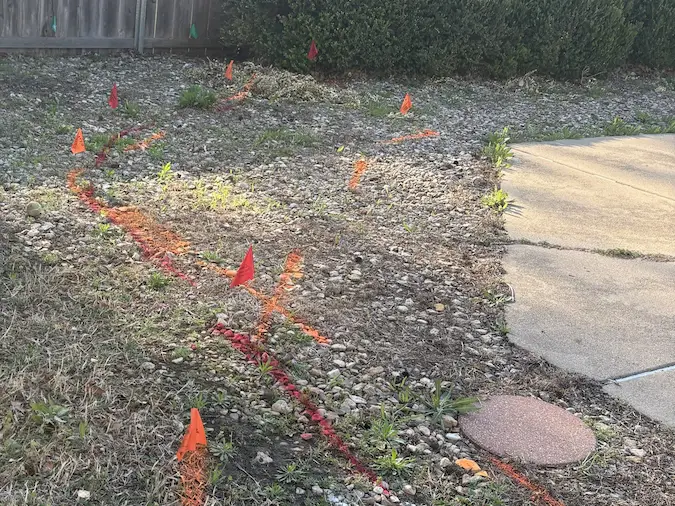 Sewer route and underground utilities marked in a residential yard