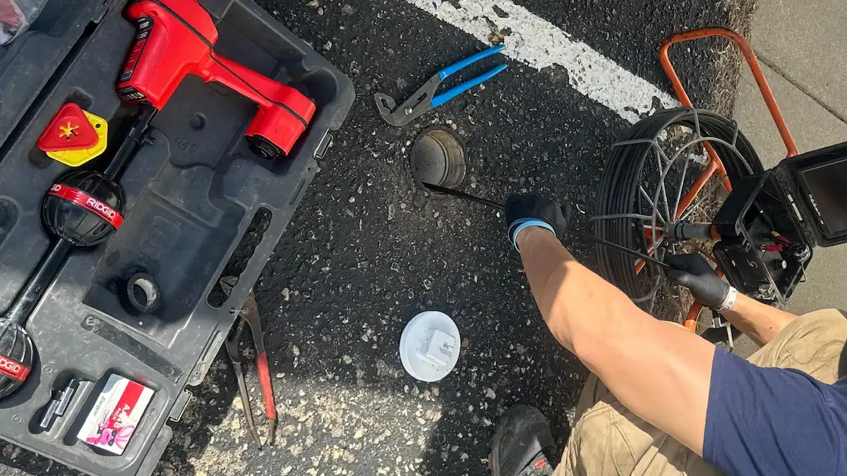 PD Plumbing technician performing a sewer camera inspection through an exterior cleanout in Wichita