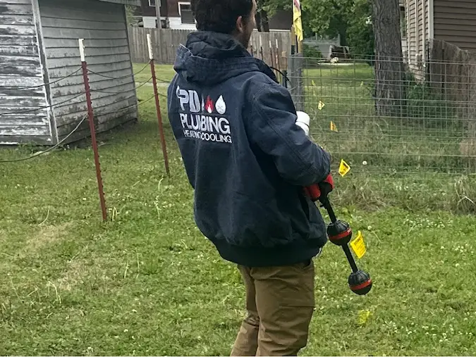 PD Plumbing technician locating a sewer route above ground