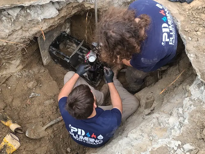 PD Plumbing crew operating pipe bursting equipment