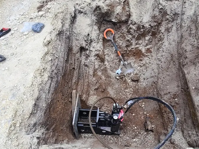 Controlled trenchless sewer access pit beside concrete