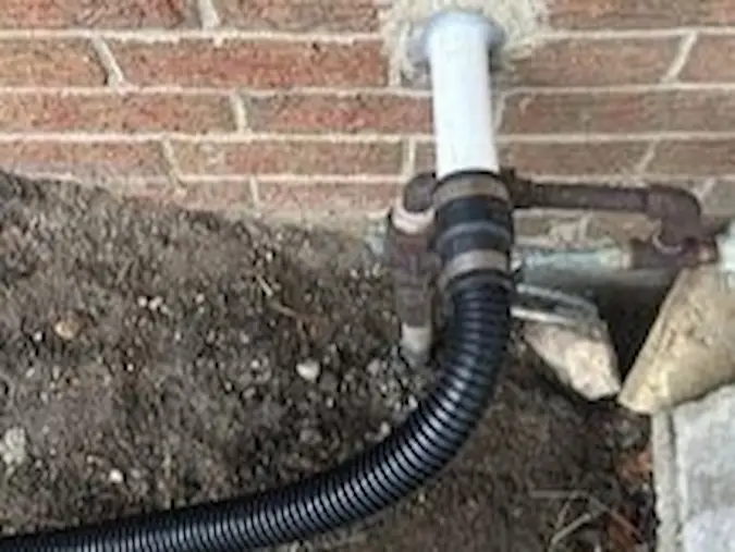 Exterior sump pump discharge line extension