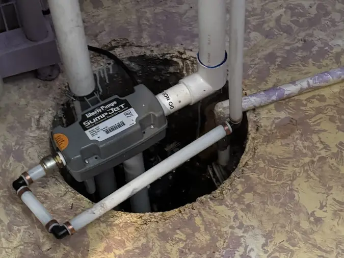 Water-powered backup sump pump installed in a basement