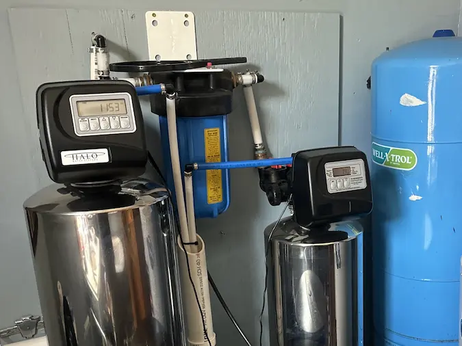 HALO whole-home water-treatment tanks installed alongside plumbing equipment