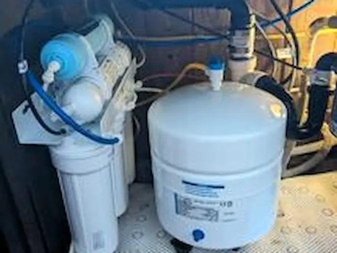 Under-sink reverse-osmosis filter housings and storage tank