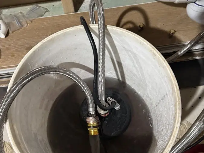 Tankless water heater being flushed during maintenance by PD Plumbing